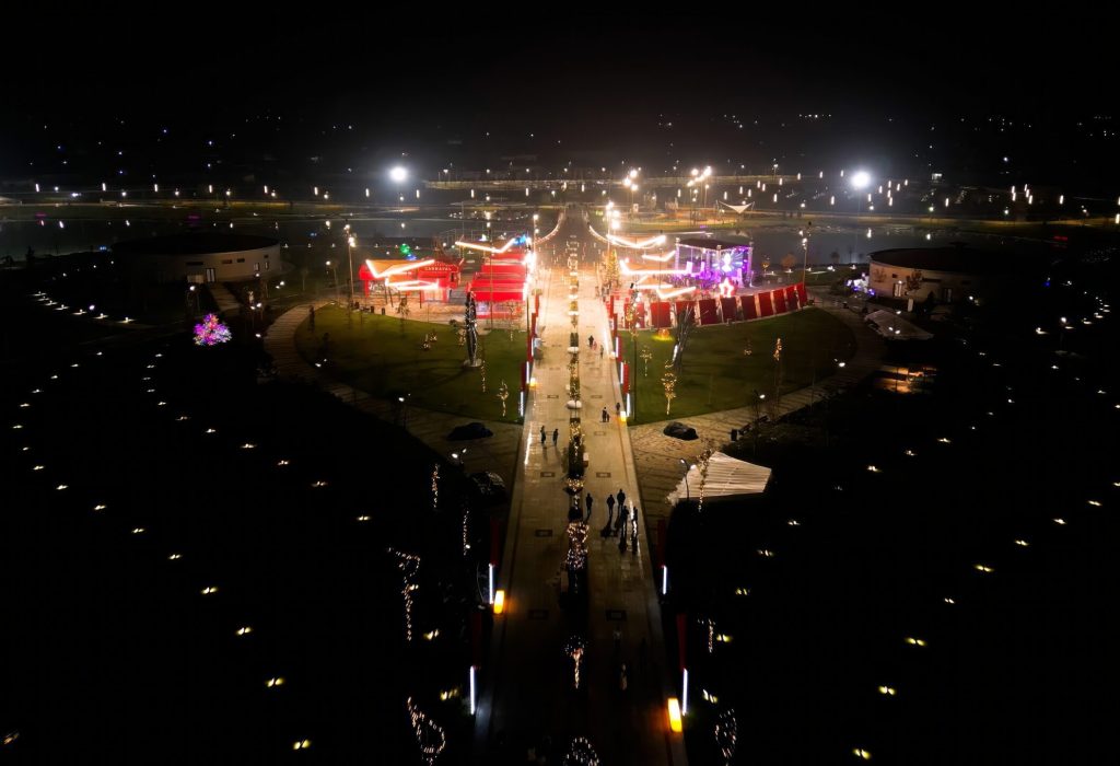 Tashkent, Uzbekistan - December 14, 2022: Aerial view of the Yangi Ozbekiston (New Uzbekistan) park with illuminated Huma bird in Tashkent city at night
